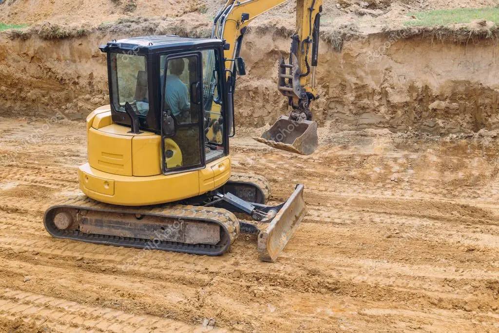Excavator grading a building site